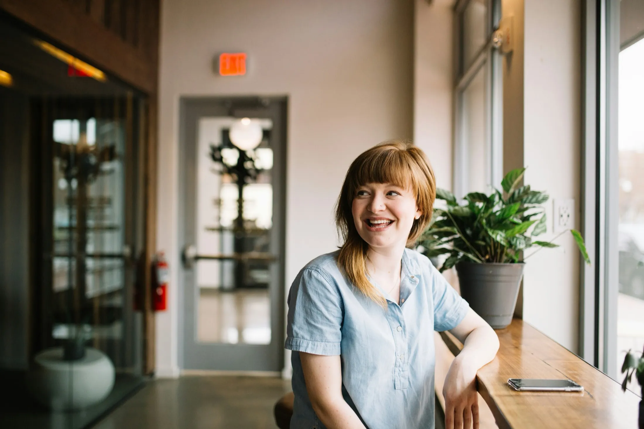 A customer smiling during a call at her counter